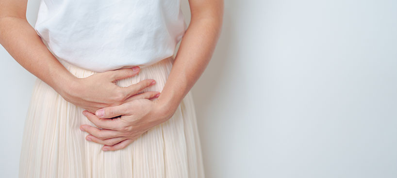 person with their hands on their pelvis